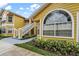 Close-up of building exterior showcasing a unique arched window and landscaping at 8718 Rain Forest Pl # C, Kissimmee, FL 34747