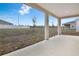 Covered patio overlooks a large backyard at 883 Griffon Ave, Lake Alfred, FL 33850
