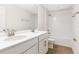 Bathroom with double vanity, tub, and neutral tile flooring at 883 Griffon Ave, Lake Alfred, FL 33850