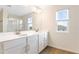 Double vanity bathroom with modern finishes and a large mirror at 883 Griffon Ave, Lake Alfred, FL 33850