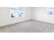 Spacious bedroom with neutral carpeting and large windows at 883 Griffon Ave, Lake Alfred, FL 33850