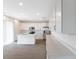 Bright kitchen featuring white cabinets, an island, and stainless steel appliances at 883 Griffon Ave, Lake Alfred, FL 33850