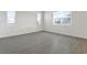 Spacious living room with neutral tile flooring and multiple windows at 883 Griffon Ave, Lake Alfred, FL 33850