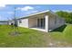 The back of the house has a covered patio and sliding glass doors leading into the home at 4220 Sawtooth Ct, Tavares, FL 32778
