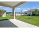 The backyard has a covered patio with well maintained lawn and white fencing at 4220 Sawtooth Ct, Tavares, FL 32778