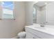 Bathroom featuring a white vanity, ample lighting, and a large window for natural light at 4220 Sawtooth Ct, Tavares, FL 32778