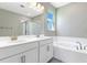 Bright bathroom features double sink vanity with a separate tub and shower at 4220 Sawtooth Ct, Tavares, FL 32778