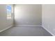 Minimalist bedroom featuring soft carpeting, neutral-toned walls, and a bright window for natural light at 4220 Sawtooth Ct, Tavares, FL 32778