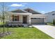 Beautiful single Gathering home with well-manicured lawn and neutral toned exterior with red shutters, stone accents and attached garage at 4220 Sawtooth Ct, Tavares, FL 32778