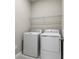 The utility room has a washer and dryer with wire shelving above at 4220 Sawtooth Ct, Tavares, FL 32778