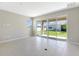 Bright living room boasting tile floors, natural light, and sliding doors that open to a backyard at 4220 Sawtooth Ct, Tavares, FL 32778