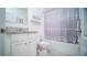 Neat bathroom with white cabinets, granite counter, toilet and shower with curtain at 2378 White Lilly Dr, Kissimmee, FL 34747