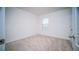 An empty carpeted bedroom features a window and neutral decor at 2378 White Lilly Dr, Kissimmee, FL 34747
