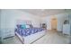 Bedroom with neutral carpet, desk, en suite bathroom and ample natural light from a large window at 2378 White Lilly Dr, Kissimmee, FL 34747