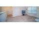 Bright bonus room featuring neutral carpet, decor, and plenty of natural light from a large window at 2378 White Lilly Dr, Kissimmee, FL 34747