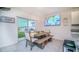 Bright dining area next to a patio door and TV screen at 2378 White Lilly Dr, Kissimmee, FL 34747