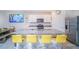 Modern kitchen showcasing an island with barstool seating, stainless appliances, and granite countertops at 2378 White Lilly Dr, Kissimmee, FL 34747