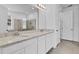 Elegant bathroom with double sinks, quartz countertops, and a walk-in shower at 3875 Bowfin Trl, Kissimmee, FL 34746