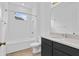 Clean bathroom with dark vanity, bathtub, and tiled floor at 3875 Bowfin Trl, Kissimmee, FL 34746