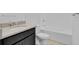 Modern bathroom with dark vanity, bathtub, and tiled floor at 3875 Bowfin Trl, Kissimmee, FL 34746