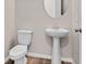 Clean bathroom with pedestal sink, toilet and tiled floor at 3875 Bowfin Trl, Kissimmee, FL 34746