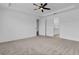 Main bedroom with ceiling fan and attached bathroom at 3875 Bowfin Trl, Kissimmee, FL 34746
