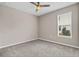 Bright bedroom with carpeted floor, window, and ceiling fan at 3875 Bowfin Trl, Kissimmee, FL 34746