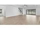 Open living room with tile floors and sliding glass doors at 3875 Bowfin Trl, Kissimmee, FL 34746