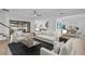 Bright living room with open floor plan, stylish furniture, and access to backyard patio at 3875 Bowfin Trl, Kissimmee, FL 34746