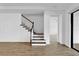 Modern staircase with wooden steps and white railing at 3875 Bowfin Trl, Kissimmee, FL 34746