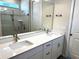 Bathroom with a double sink vanity, large mirror, bright lights, and modern fixtures at 4520 Gliding Wave St, Winter Garden, FL 34787
