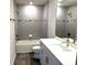 Updated bathroom featuring sleek gray subway tile, modern vanity, and a bathtub with shower at 4520 Gliding Wave St, Winter Garden, FL 34787