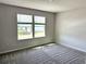 Bedroom featuring plush gray carpet and two windows that allow in lots of natural light at 4520 Gliding Wave St, Winter Garden, FL 34787