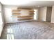 Spacious bonus room with plush carpeting, floating shelves, and plenty of natural light at 4520 Gliding Wave St, Winter Garden, FL 34787
