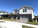 Charming two-story home with a gray stone accent wall, and a well-manicured lawn, on a sunny day at 4520 Gliding Wave St, Winter Garden, FL 34787