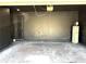 Spacious two car garage with sleek black walls and sealed concrete floors at 4520 Gliding Wave St, Winter Garden, FL 34787