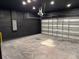 Spacious two car garage with sleek black walls and sealed concrete floors at 4520 Gliding Wave St, Winter Garden, FL 34787
