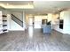 Open-concept kitchen boasts a spacious island, stainless steel appliances, and white cabinetry at 4520 Gliding Wave St, Winter Garden, FL 34787