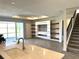 Living room features a modern entertainment center, tile flooring, and natural light from the sliding glass doors at 4520 Gliding Wave St, Winter Garden, FL 34787
