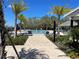 Resort-style pool surrounded by palm trees, lounge chairs, and lush landscaping in a community at 4520 Gliding Wave St, Winter Garden, FL 34787