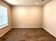 Bright, spacious room features wood-look flooring and a large window that allows natural light to stream in at 4520 Gliding Wave St, Winter Garden, FL 34787
