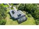 Back exterior featuring a screened enclosure with a pool, a backyard and solar panels at 14121 Bella Ln, Orlando, FL 32832