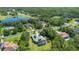 Aerial view of neighborhood, lakes, and home with solar panels and screened in pool at 14121 Bella Ln, Orlando, FL 32832