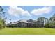 Expansive lawn with a covered lanai including ample space for seating and dining at 14121 Bella Ln, Orlando, FL 32832