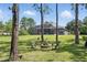 Large backyard with a fire pit and seating area, with a screened-in lanai on the home at 14121 Bella Ln, Orlando, FL 32832