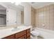 Clean bathroom features tiled walls, tub with shower, and vanity with marble countertop at 14121 Bella Ln, Orlando, FL 32832