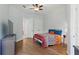 Bright bedroom features a ceiling fan, wood floors, double closets and an ensuite bathroom at 14121 Bella Ln, Orlando, FL 32832