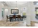 Elegant dining room featuring a large table, decorative rug, and ample natural light at 14121 Bella Ln, Orlando, FL 32832