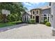 Close up of the driveway leading to the home's entrance with stone facade at 14121 Bella Ln, Orlando, FL 32832