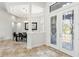 Elegant entryway with decorative glass doors, tile flooring, and views into the dining room at 14121 Bella Ln, Orlando, FL 32832
